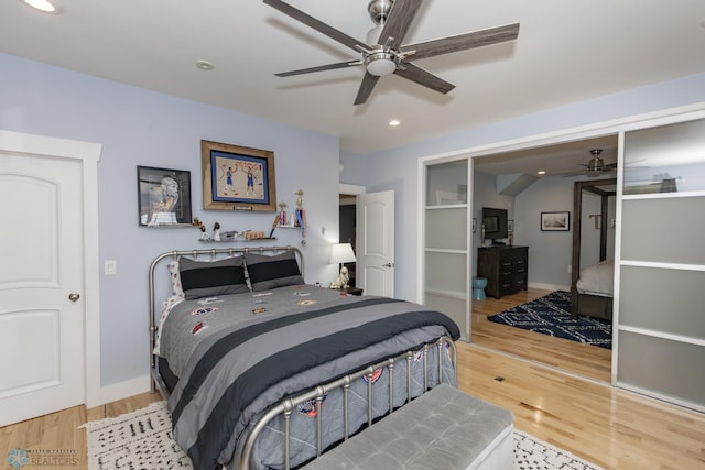 bedroom with light hardwood / wood-style floors and ceiling fan