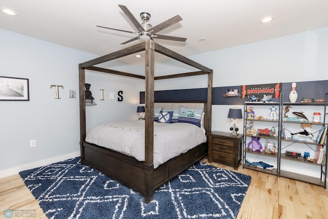 bedroom with light hardwood / wood-style floors and ceiling fan