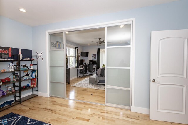 interior space with ceiling fan and light hardwood / wood-style floors