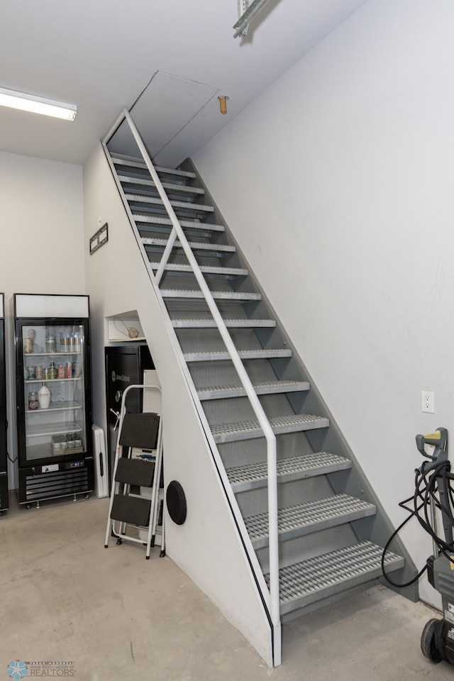 stairway featuring concrete floors