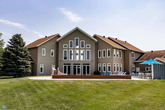 back of property featuring a patio and a lawn