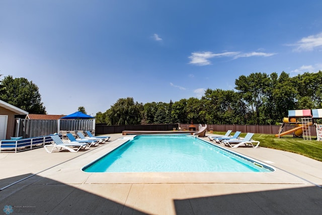 view of pool featuring a patio and a playground