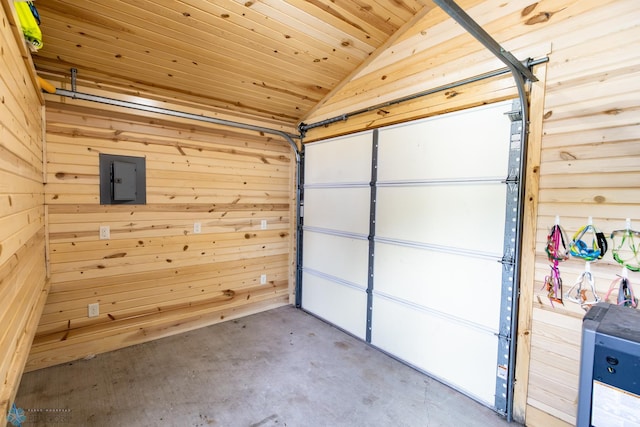 garage featuring wooden ceiling, wooden walls, and electric panel