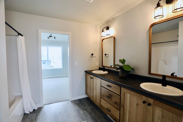 bathroom featuring shower / tub combo and dual bowl vanity