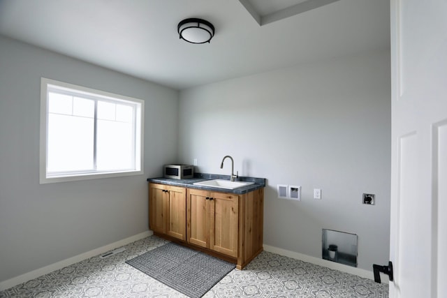 laundry area featuring sink, cabinets, light tile patterned floors, electric dryer hookup, and washer hookup