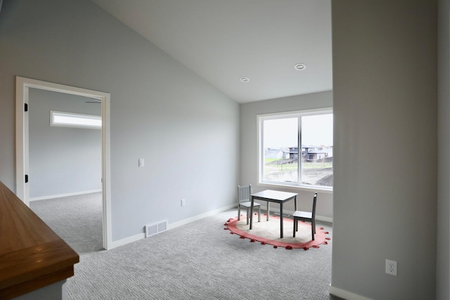 rec room featuring carpet flooring and lofted ceiling