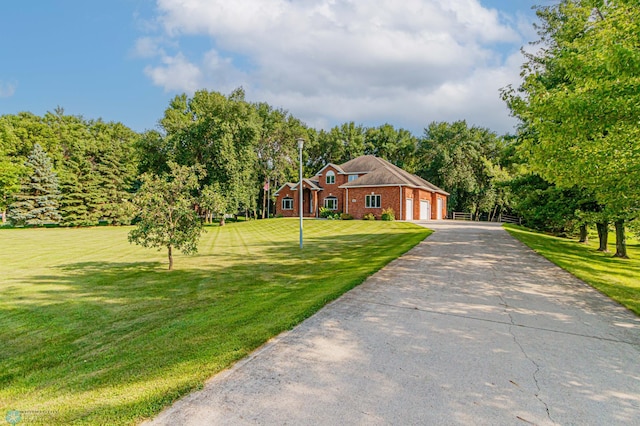 ranch-style home featuring a garage and a front lawn