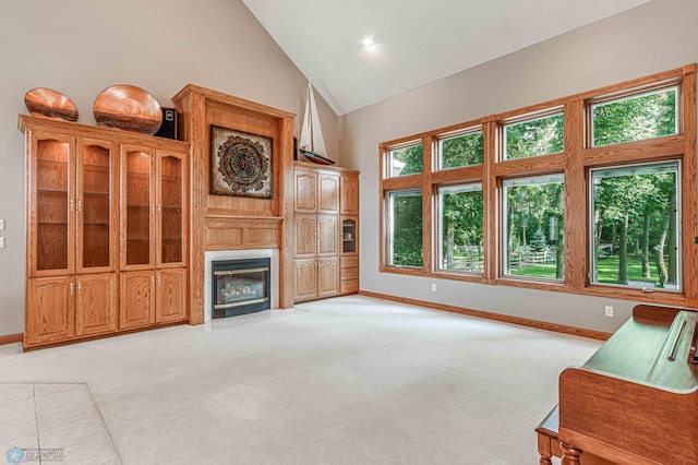 living room featuring high vaulted ceiling and light colored carpet