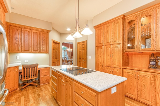 kitchen with pendant lighting, light wood-type flooring, black electric cooktop, and a kitchen island