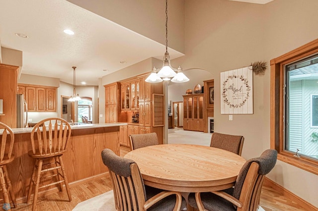 dining area with a wealth of natural light and a chandelier