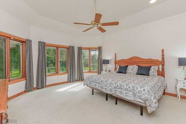 bedroom with multiple windows, light carpet, and ceiling fan