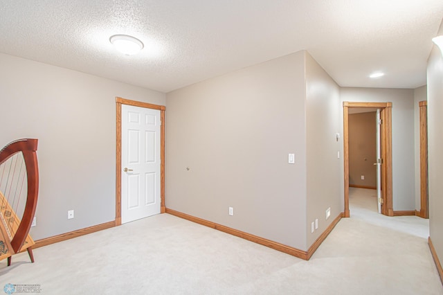 unfurnished bedroom featuring carpet and a textured ceiling