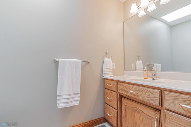 bathroom with a skylight and vanity