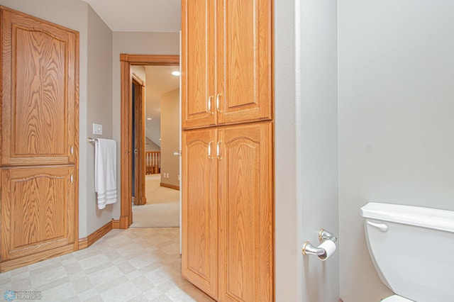 bathroom featuring toilet and tile patterned flooring