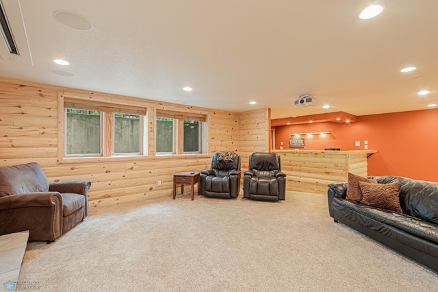 carpeted living room featuring log walls