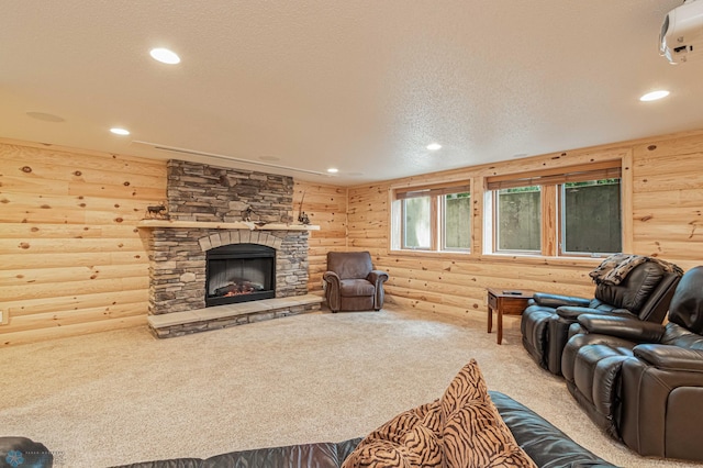 carpeted living room featuring log walls, a fireplace, and a textured ceiling