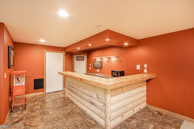 interior space with light brown cabinetry and dark tile patterned flooring