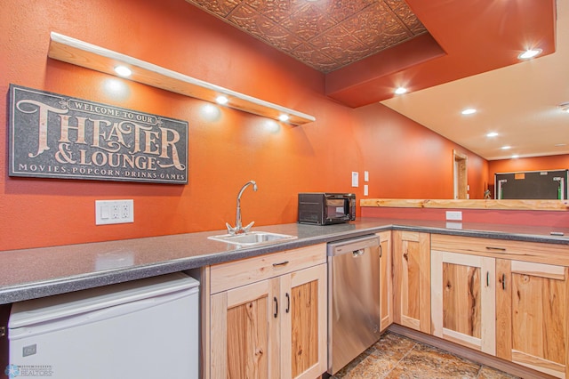 kitchen featuring light brown cabinetry, tile patterned floors, sink, and dishwasher