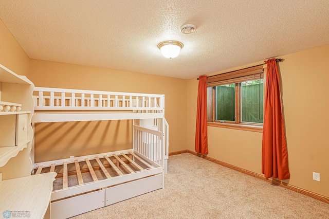 unfurnished bedroom featuring carpet and a textured ceiling