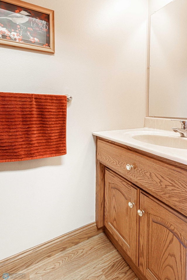 bathroom featuring vanity and hardwood / wood-style flooring