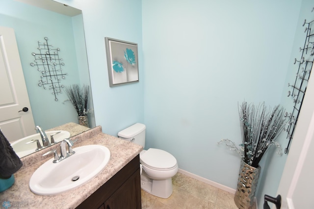 bathroom with tile patterned flooring, toilet, and vanity