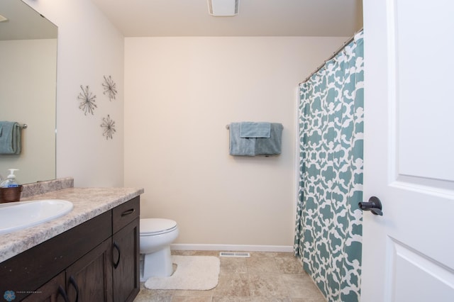 bathroom featuring tile patterned flooring, toilet, and vanity