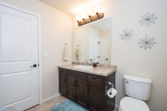 bathroom featuring tile patterned floors, toilet, and vanity