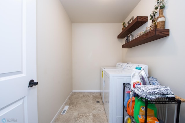 washroom with light tile patterned flooring and washing machine and dryer