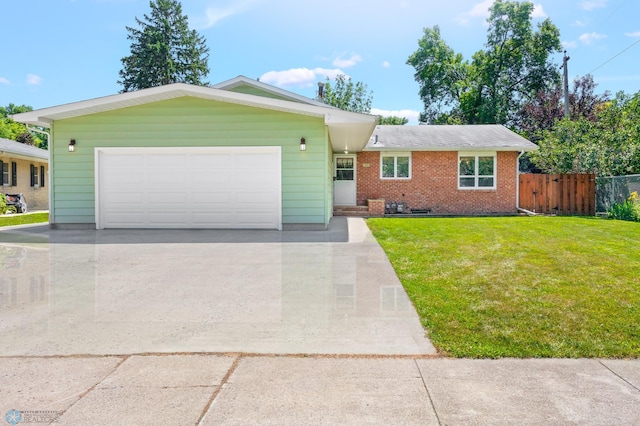 single story home with a garage and a front lawn