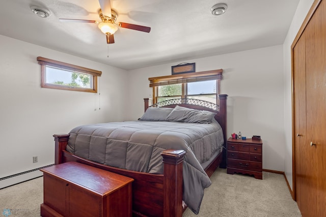 carpeted bedroom with a baseboard radiator, ceiling fan, and a closet