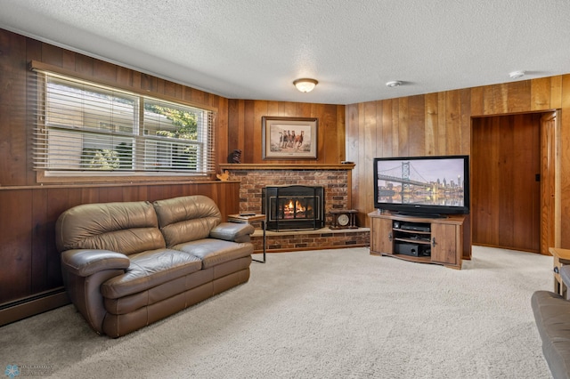 carpeted living room with a textured ceiling, wooden walls, and a brick fireplace