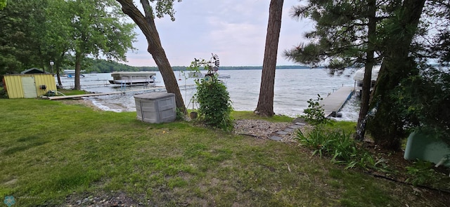 exterior space featuring a boat dock and a water view