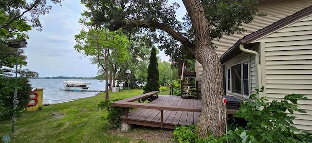 wooden terrace featuring a water view