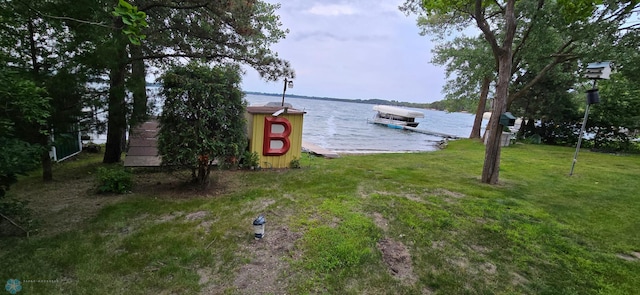 view of yard featuring a boat dock and a water view