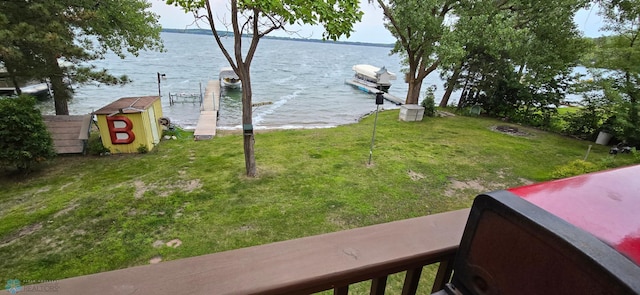 view of yard featuring a boat dock and a water view