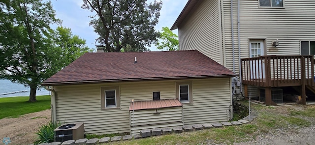 view of home's exterior featuring cooling unit and a wooden deck