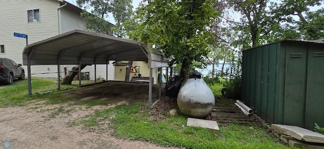 view of yard with a carport and a storage shed