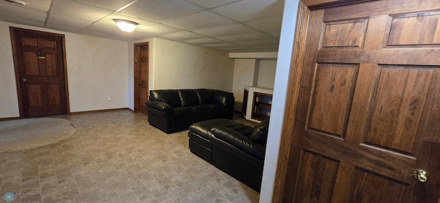 tiled living room with a drop ceiling