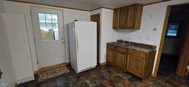 kitchen with sink, dark tile patterned floors, and white refrigerator