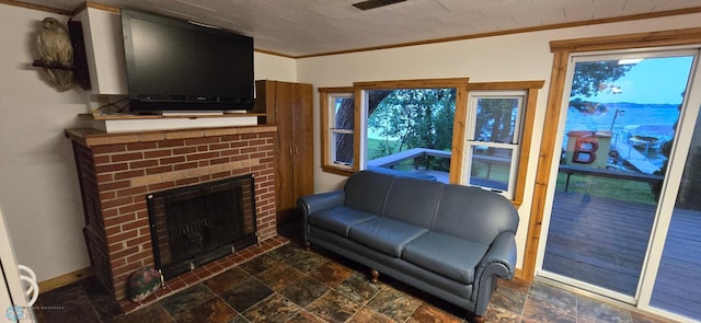 living room featuring a fireplace, crown molding, and dark tile patterned flooring