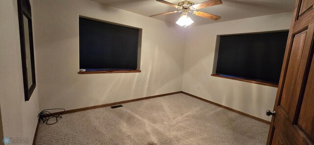 spare room featuring carpet floors and ceiling fan