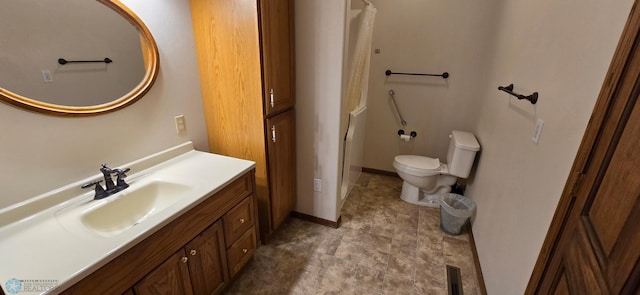 bathroom with vanity, tile patterned floors, and toilet