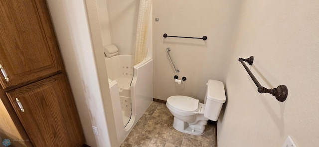 bathroom featuring tile patterned flooring and toilet