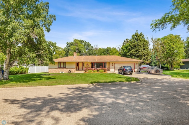 single story home with a garage and a front yard