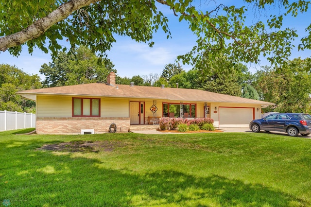 ranch-style home with a garage and a front lawn