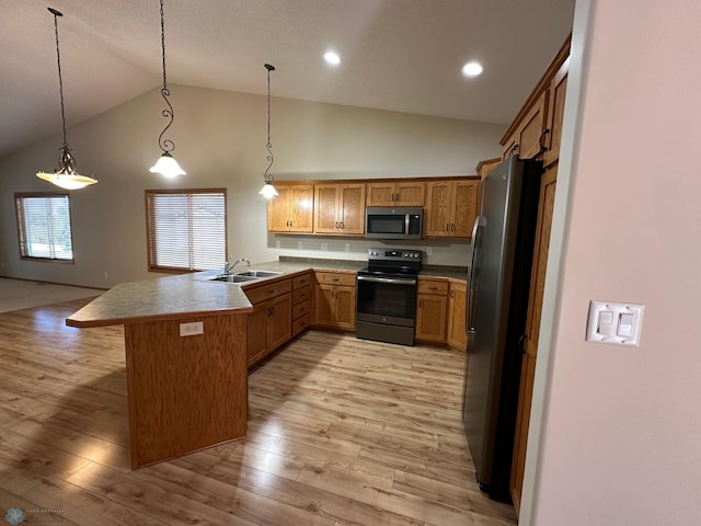 kitchen featuring appliances with stainless steel finishes, kitchen peninsula, hanging light fixtures, light hardwood / wood-style floors, and high vaulted ceiling