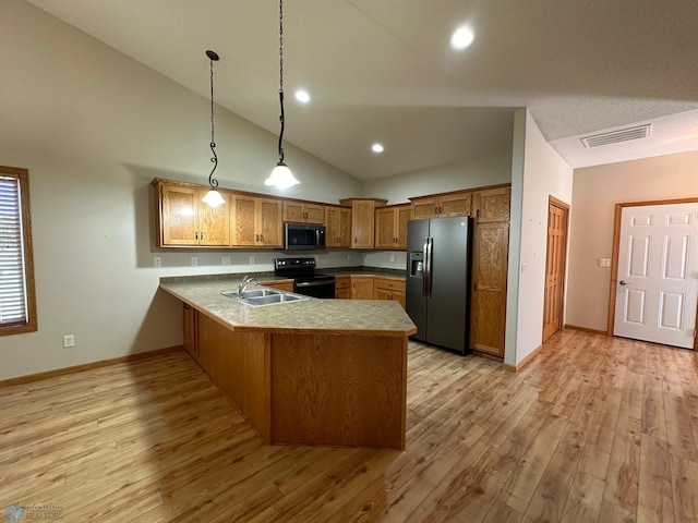 kitchen with kitchen peninsula, light hardwood / wood-style floors, hanging light fixtures, appliances with stainless steel finishes, and sink