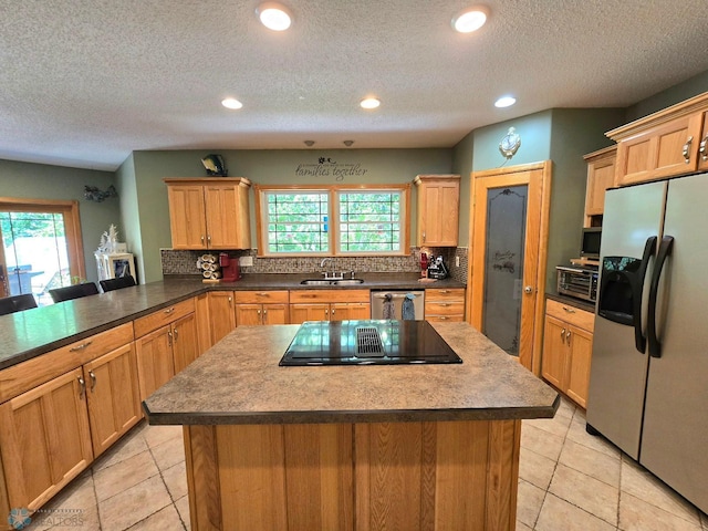 kitchen with a center island, stainless steel appliances, and light tile patterned floors