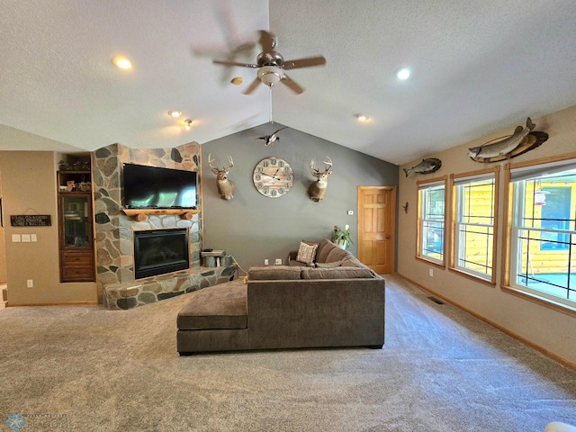 living room with a stone fireplace, a textured ceiling, lofted ceiling, and light colored carpet