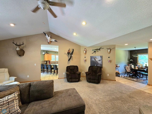 living room featuring light carpet, ceiling fan, lofted ceiling, and a textured ceiling